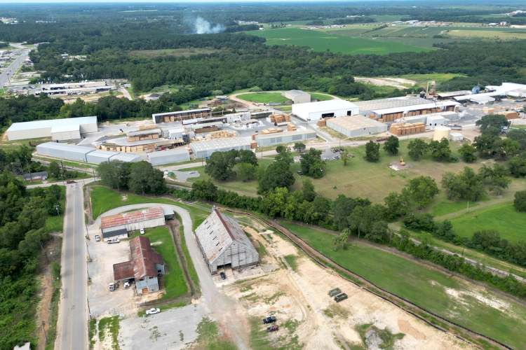 an aerial view of a large industrial area with lots of buildings and trees
