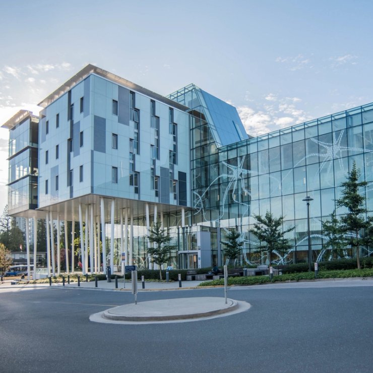 a large building with a lot of windows and trees in front of it .