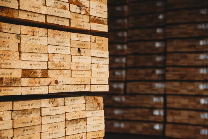 a warehouse filled with lots of wooden blocks stacked on top of each other .