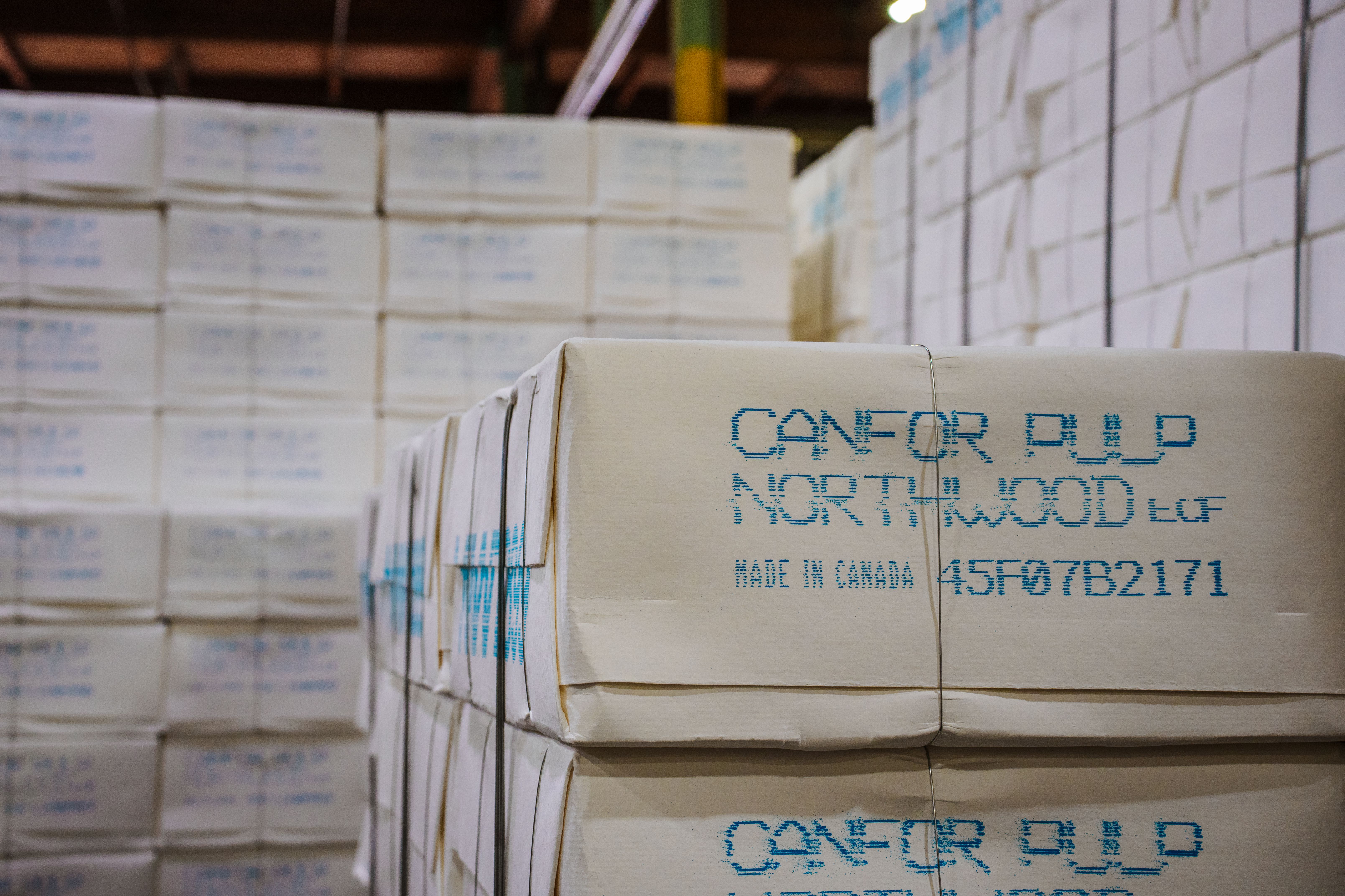 a warehouse filled with lots of boxes stacked on top of each other .