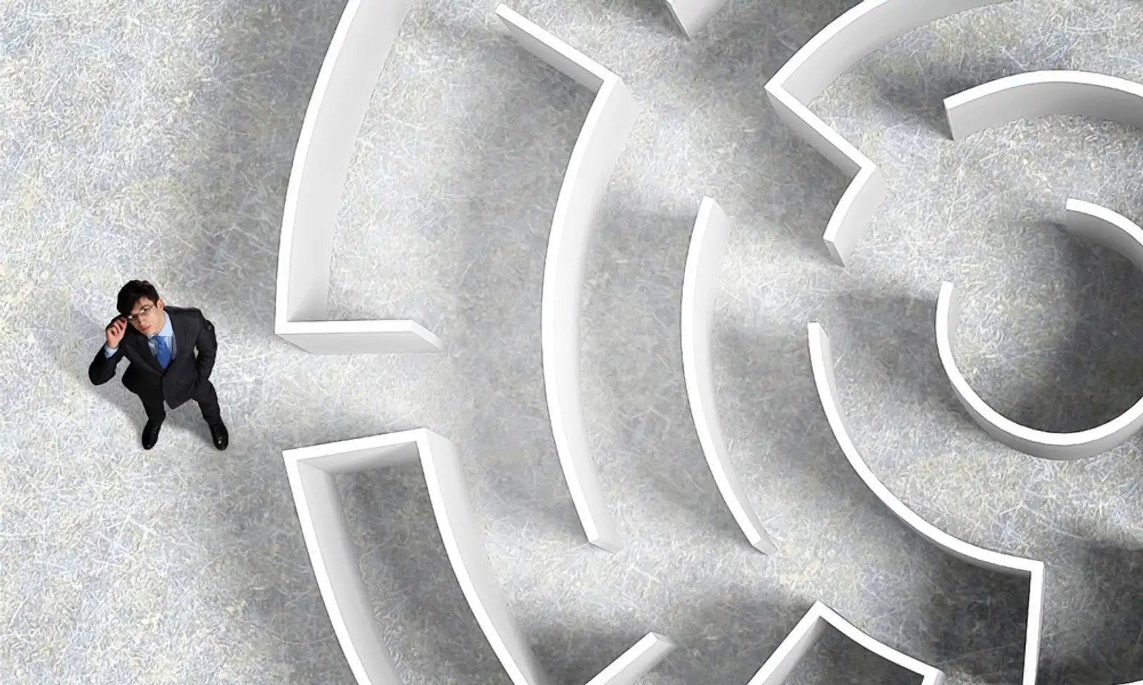 Top view of successful businessman standing near the entrance of labyrinth.jpeg