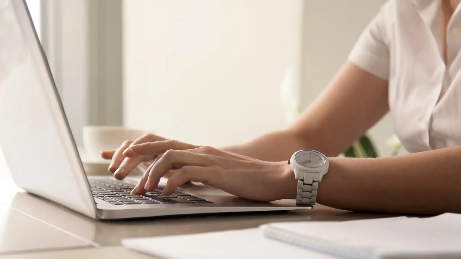 womans-hands-typing-on-laptop-at-workplace-1.jpg