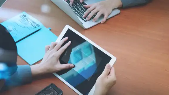 top view of two colleagues using digital pro tablet and laptop computer with Secure payment on the screen as Online shopping concept.jpeg