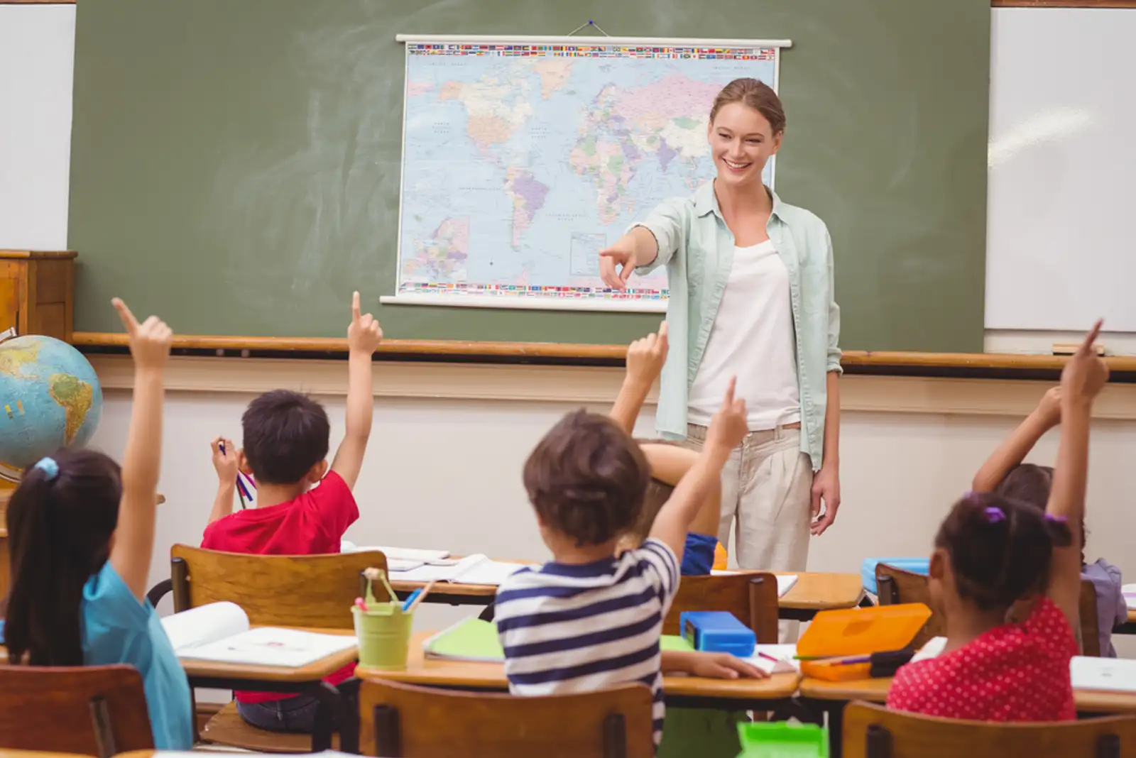 Pupils raising hand in classroom at the elementary school.jpeg
