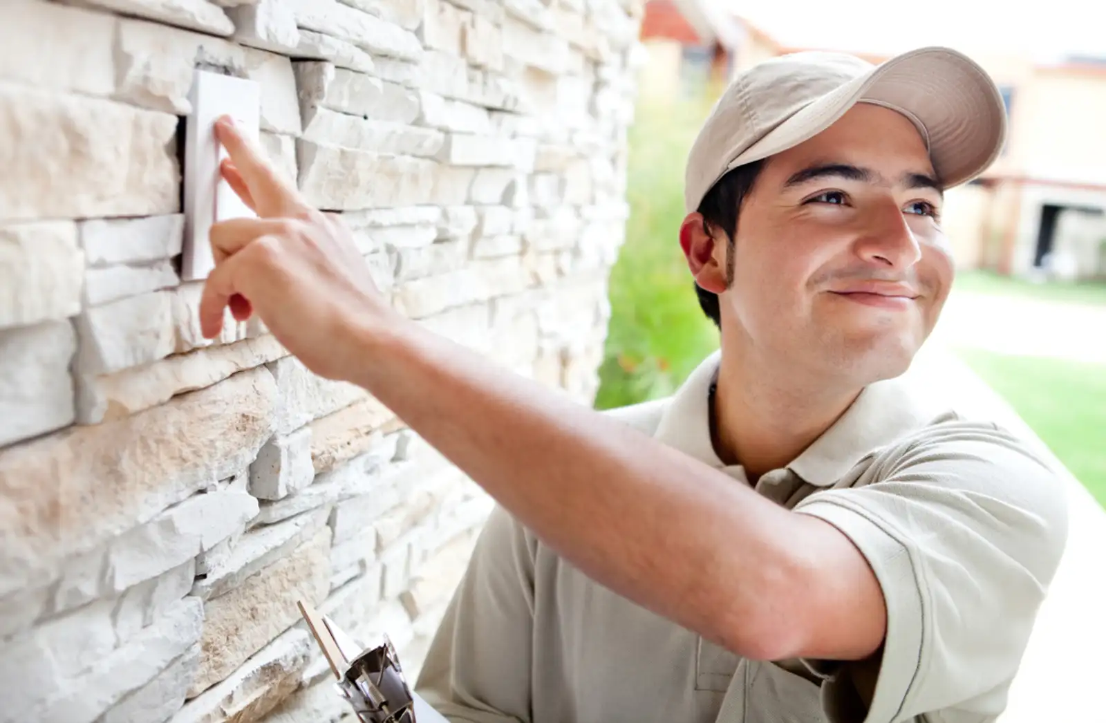 Happy delivery man outdoors ringing house doorbell.jpeg