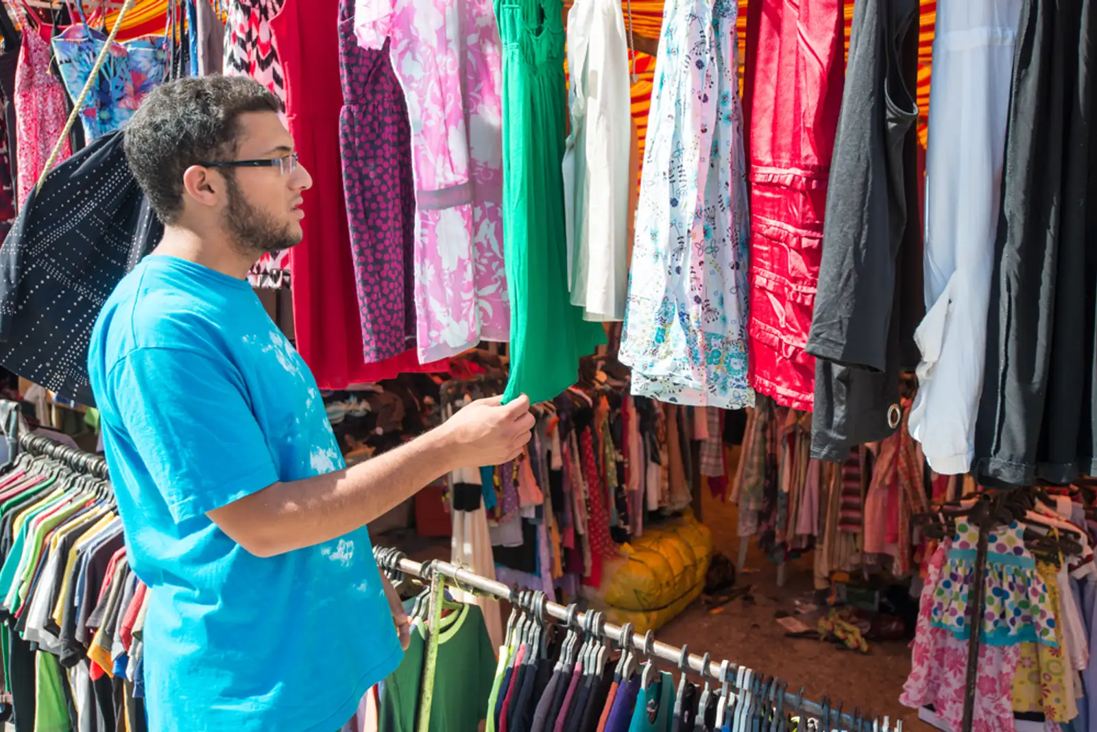 Young man buying in second hand store.jpeg