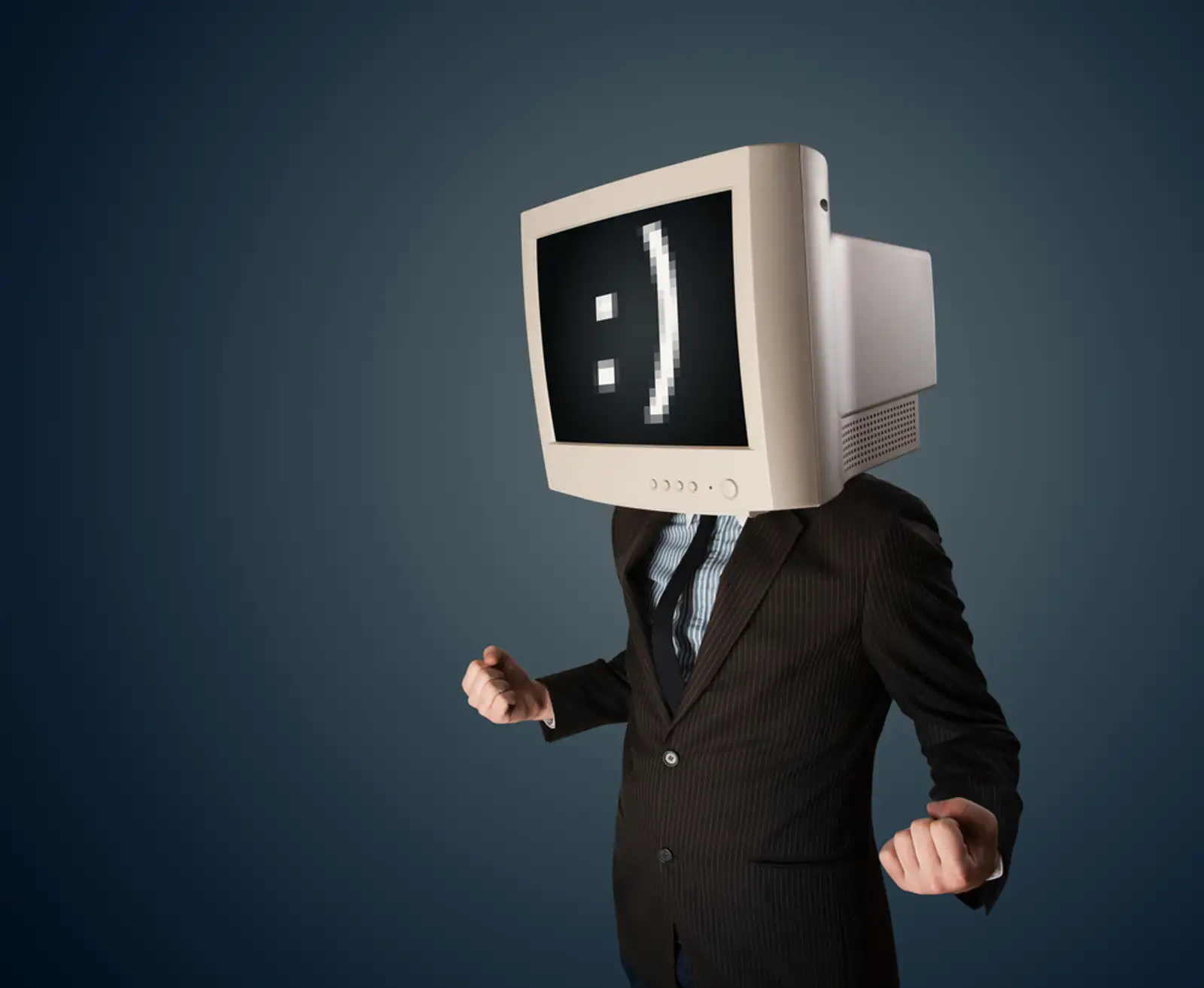 Funny young businessman with a monitor on his head and smiley on the black screen.jpeg