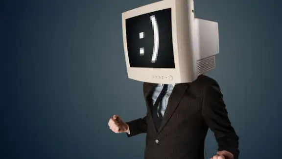 Funny young businessman with a monitor on his head and smiley on the black screen.jpeg