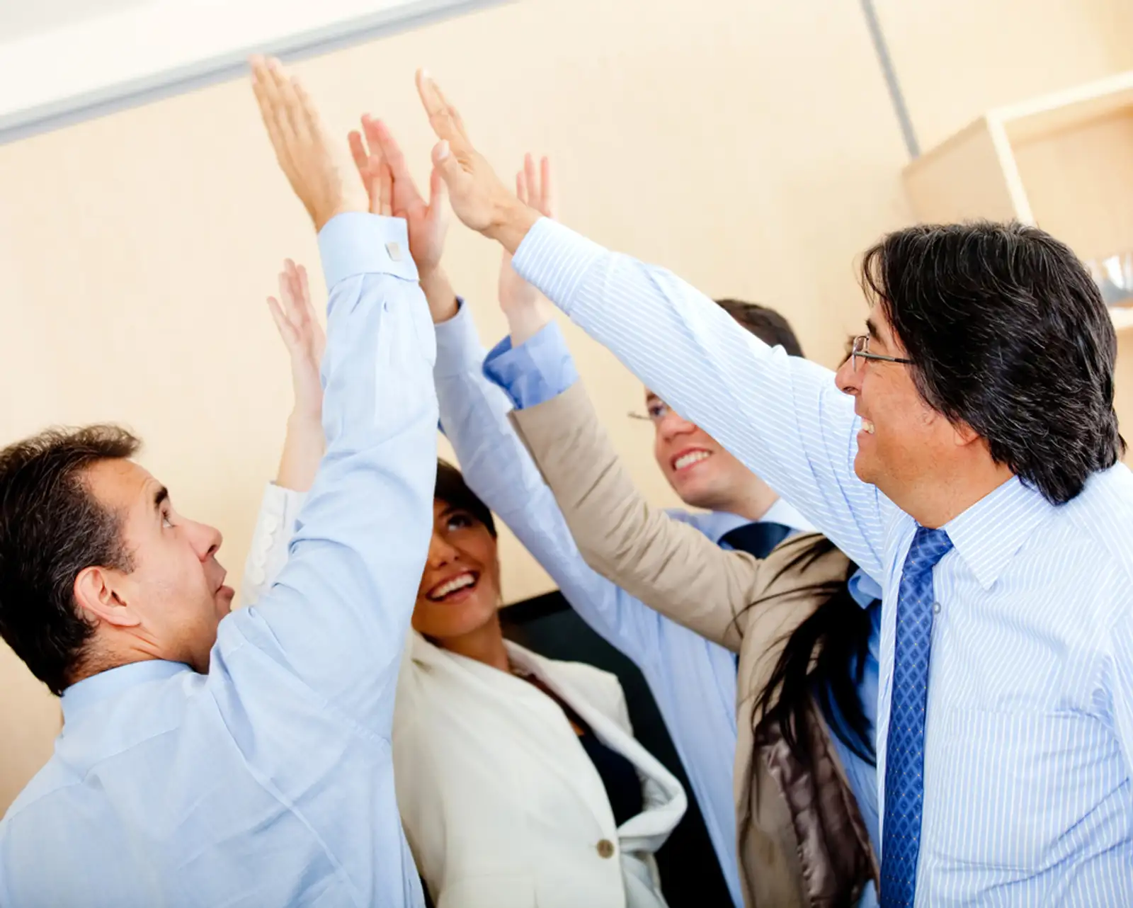 Successful business group giving a high-five at the office.jpeg