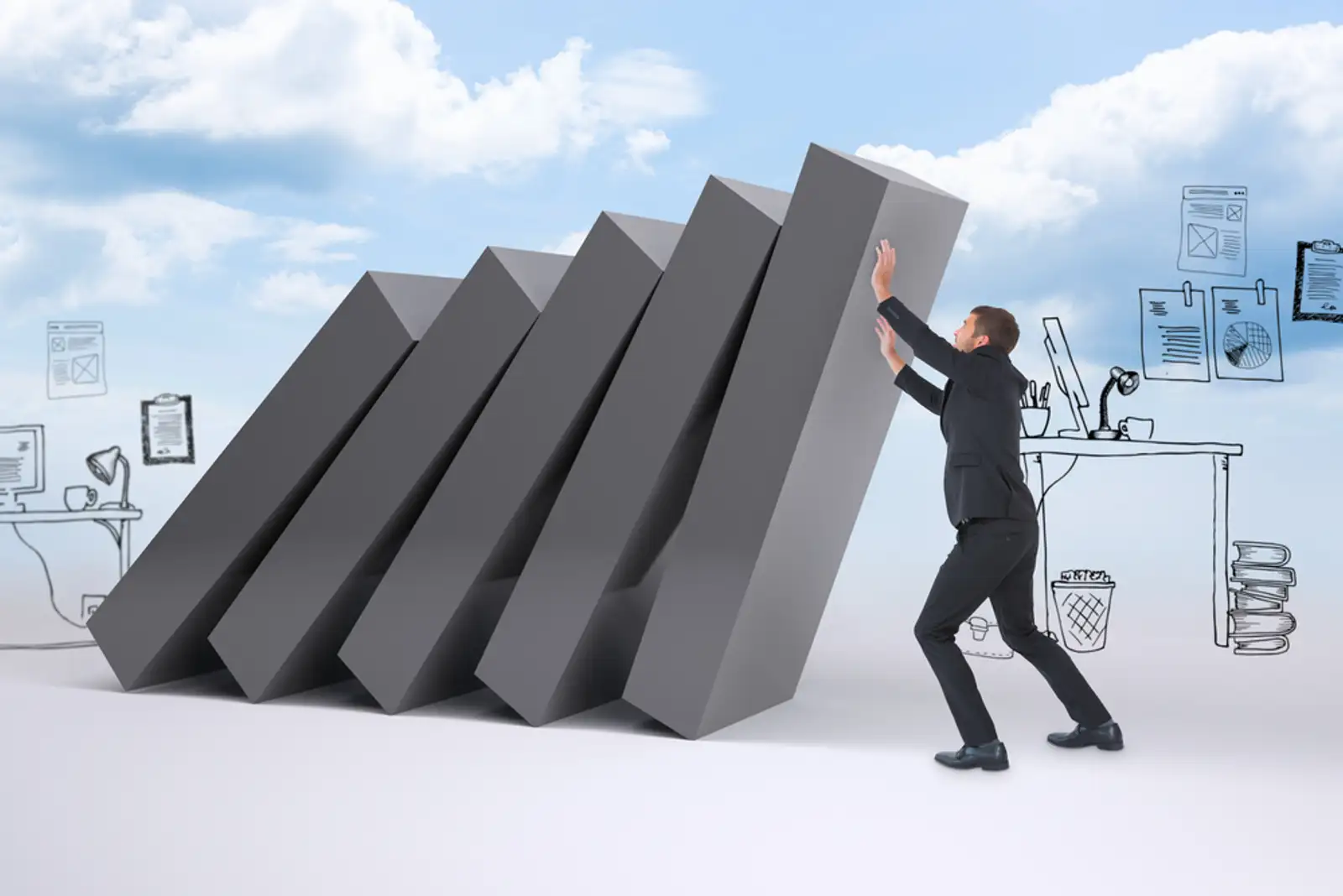 Businessman with his hands up against falling blocks.jpeg