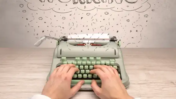 First person perspective hand writing on typewriter with cloud message concept.jpeg