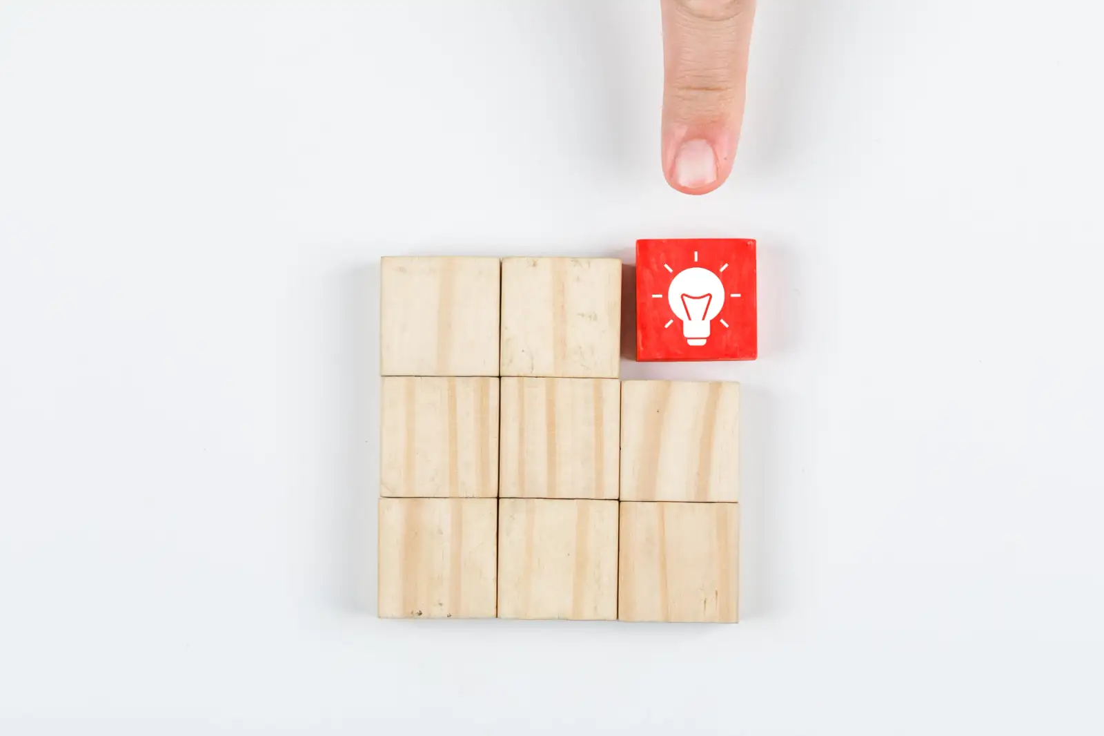 conceptual-of-idea-hand-pointing-the-idea-with-wooden-blocks-on-white-background-top-view-horizontal-image.jpg
