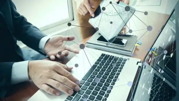 business documents on office table with smart phone and digital tablet and stylus and two colleagues discussing data in the background.jpeg