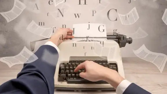 First person perspective hand typewriting with flying documents around.jpeg