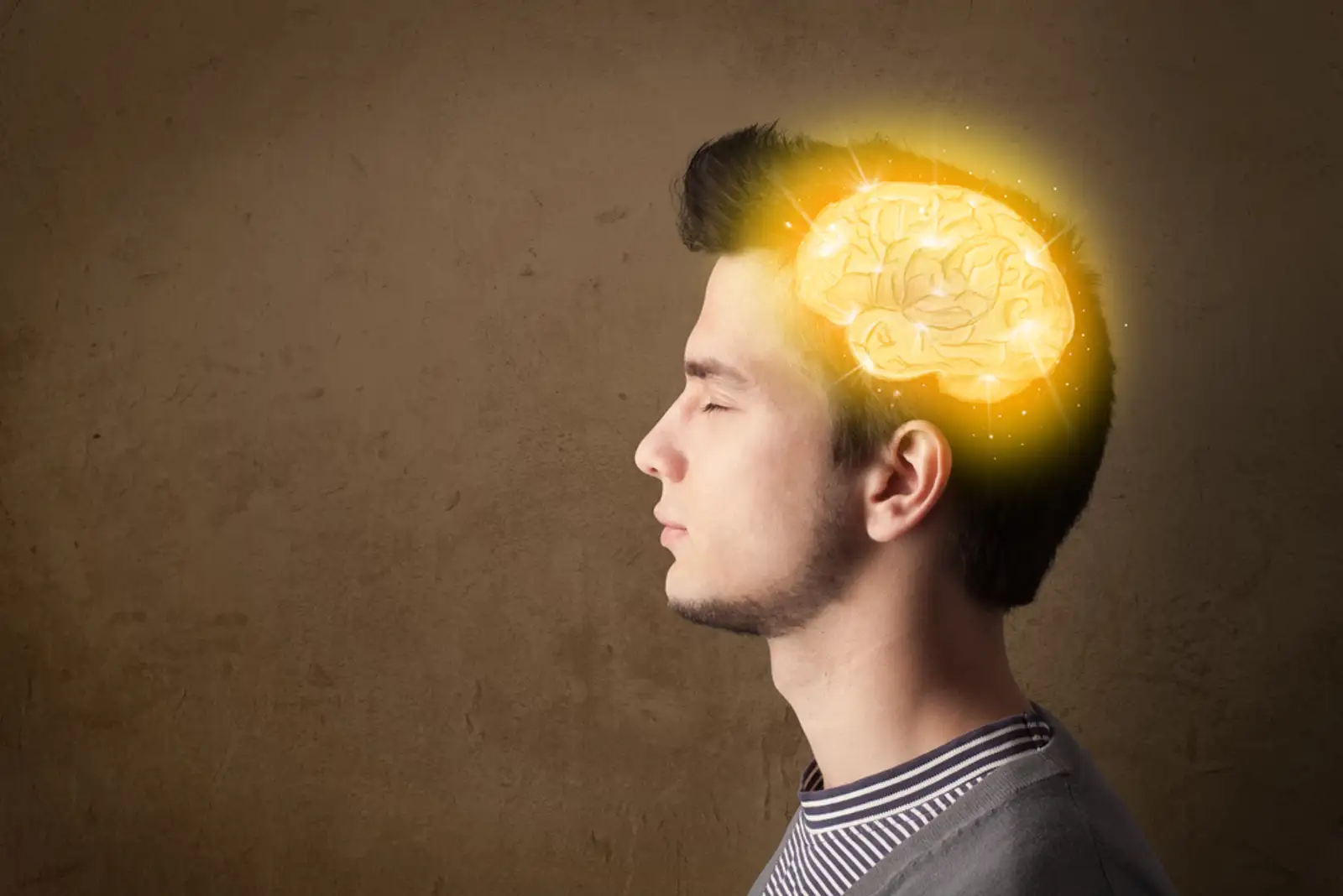 Young man thinking with glowing brain illustration.jpeg