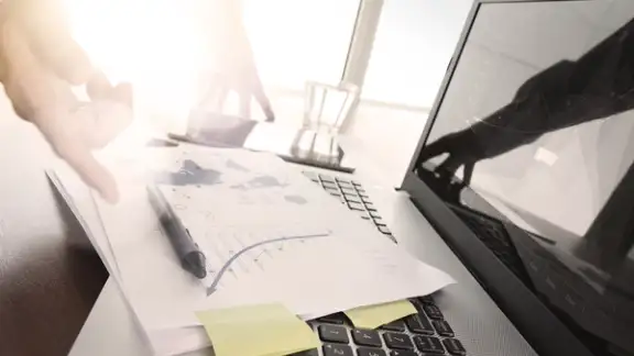 Close up of business man hand working on laptop computer with social media diagram and chart graph on wooden desk as concept.jpeg