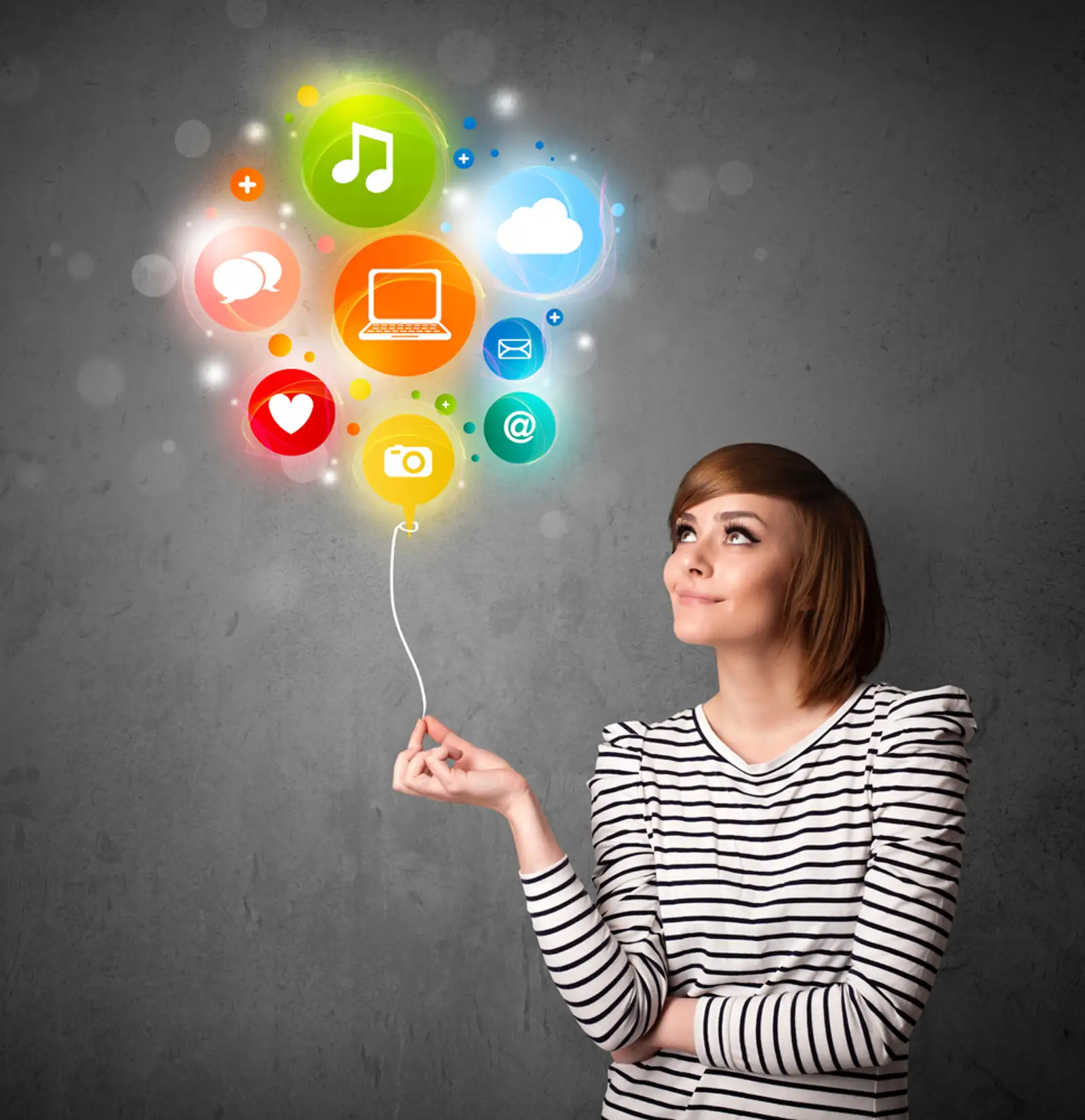 Pretty young woman holding colorful social media icons balloon.jpeg