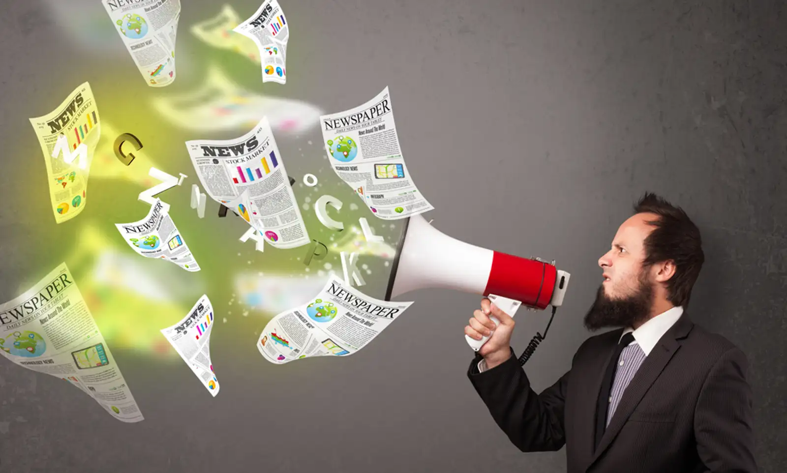 Handsome guy yelling into loudspeaker and newspapers fly out.jpeg