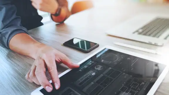 Website designer working digital tablet and computer laptop with smart phone and graphics design diagram on wooden desk as concept.jpeg