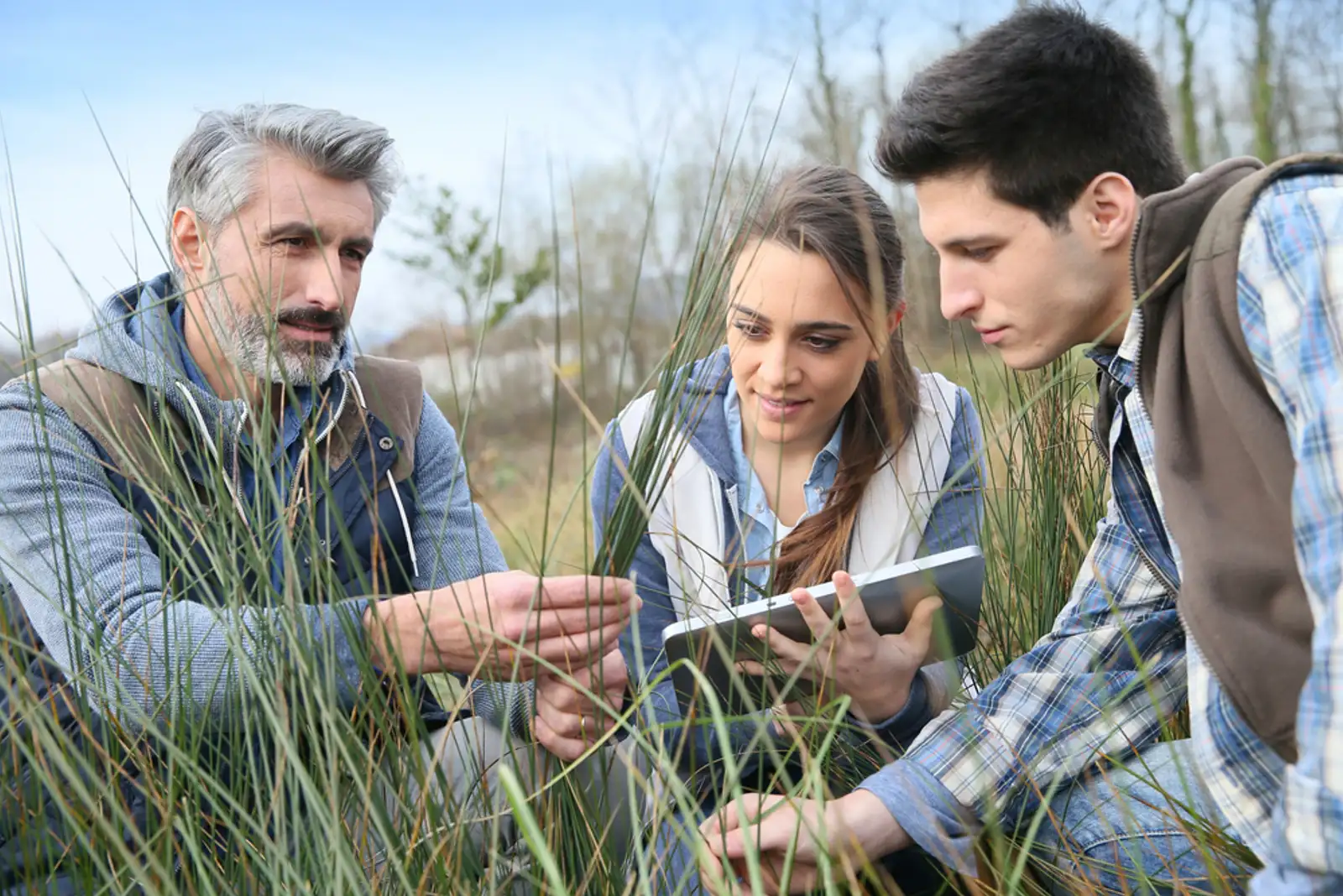 Teacher with students in agronomy looking at vegetation.jpeg