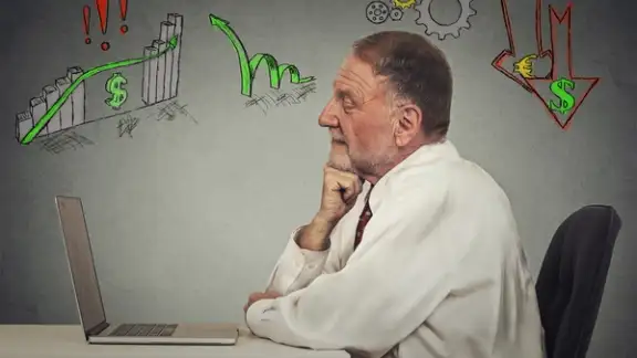 Side profile view senior business man working on computer isolated on grey wall background. Anticipation of financial crisis%2c bad%2c poor economy concept. Corporate employee thinking%2c making decisions..jpeg