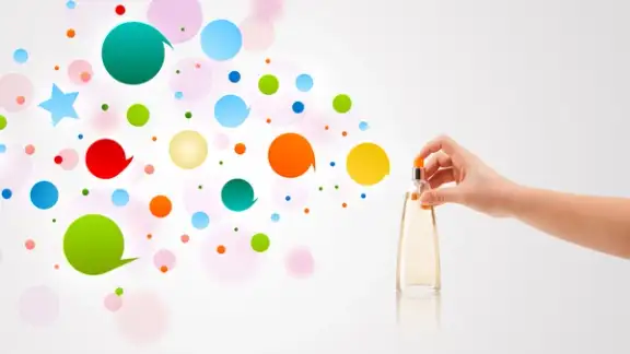 close up of woman hands spraying colorful bubbles from beautiful perfume bottle.jpeg