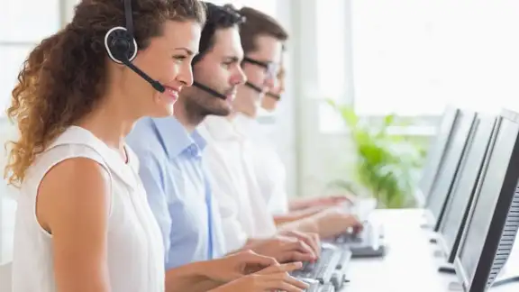 Customer service representatives working at desk in office.jpeg