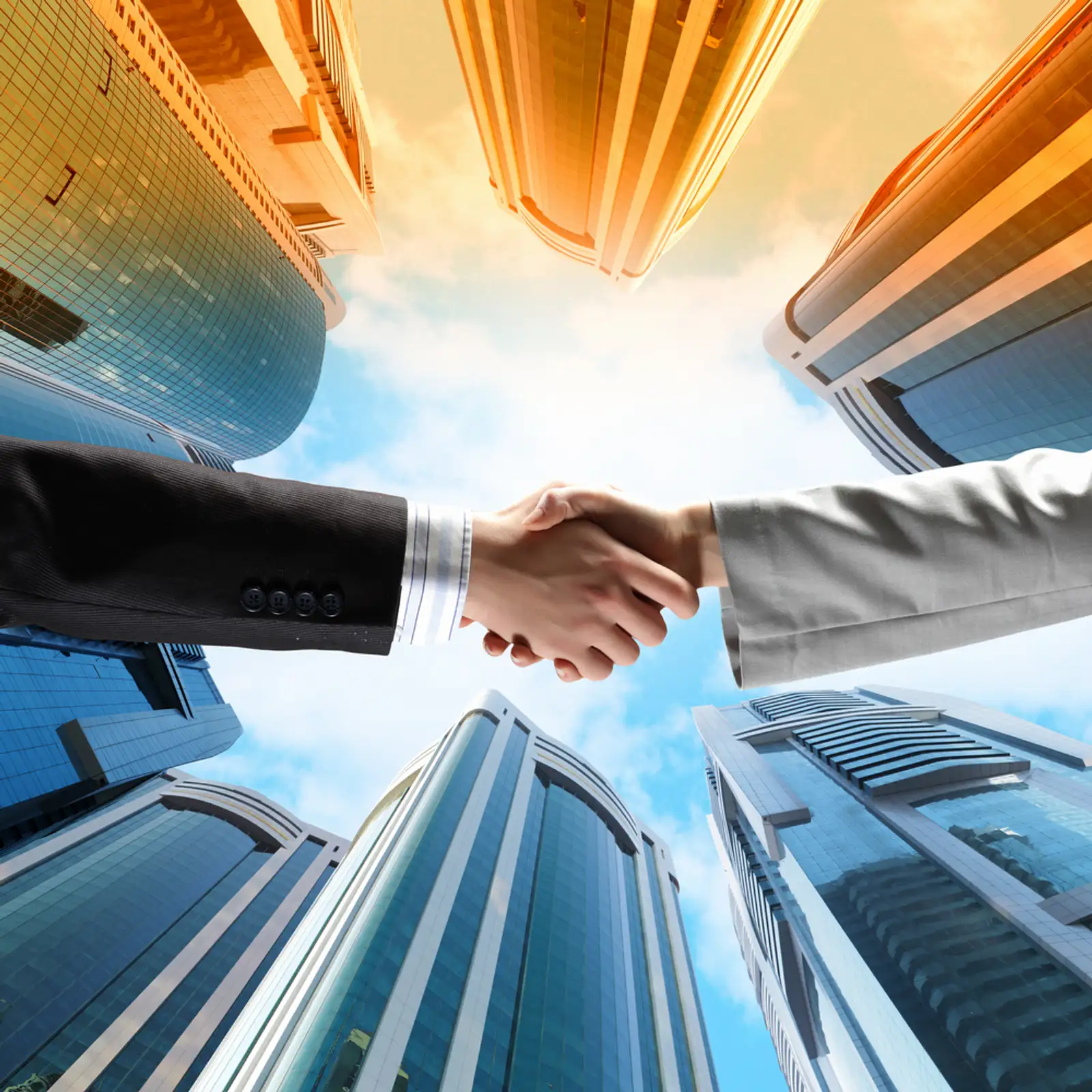 Close up image of hand shake against skyscrapers.jpeg