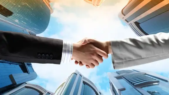 Close up image of hand shake against skyscrapers.jpeg