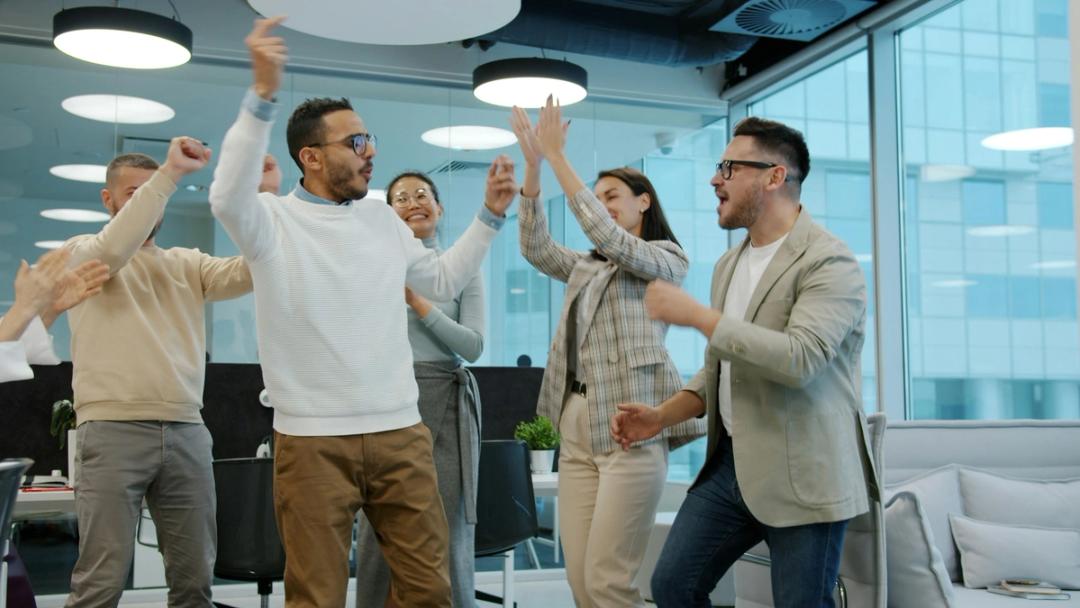 Colleagues celebrating teamwork in an office