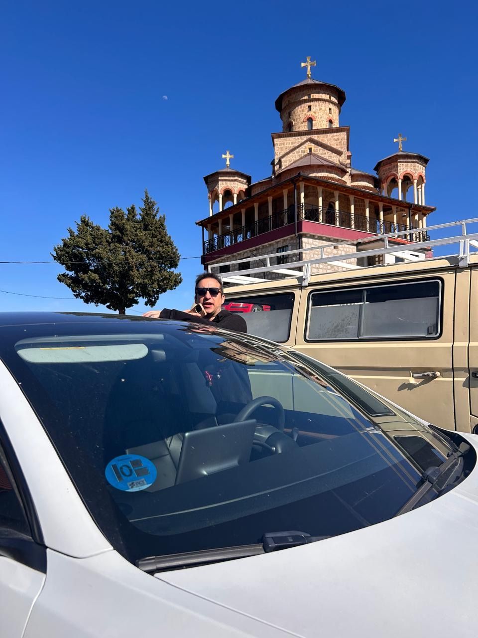Gonzalo by the car in front of an Orthodox church in the Republika Srpska
