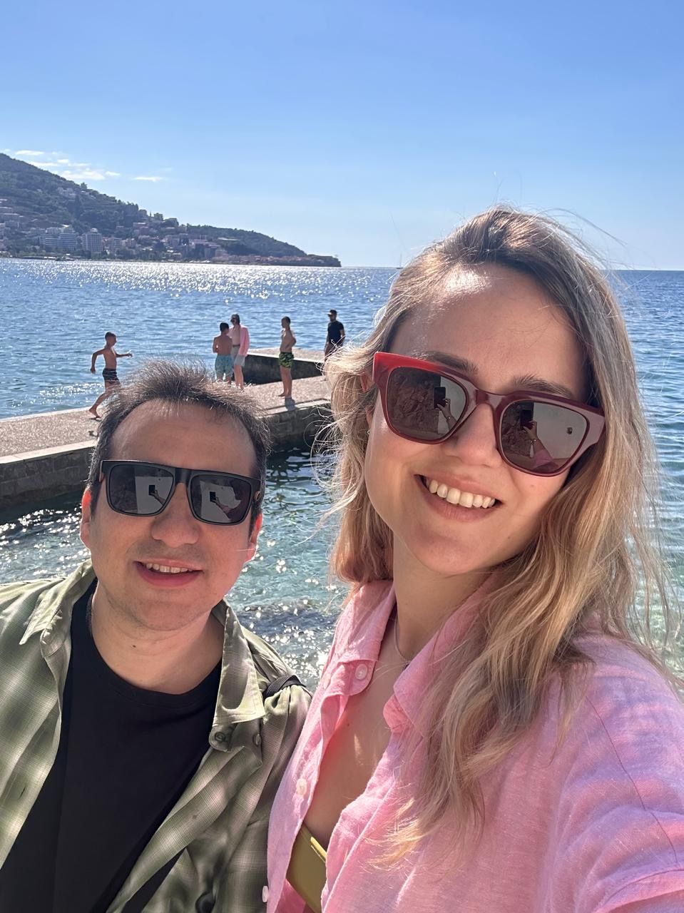 Couple selfie arriving in Budva, Montenegro, with the sea in the background