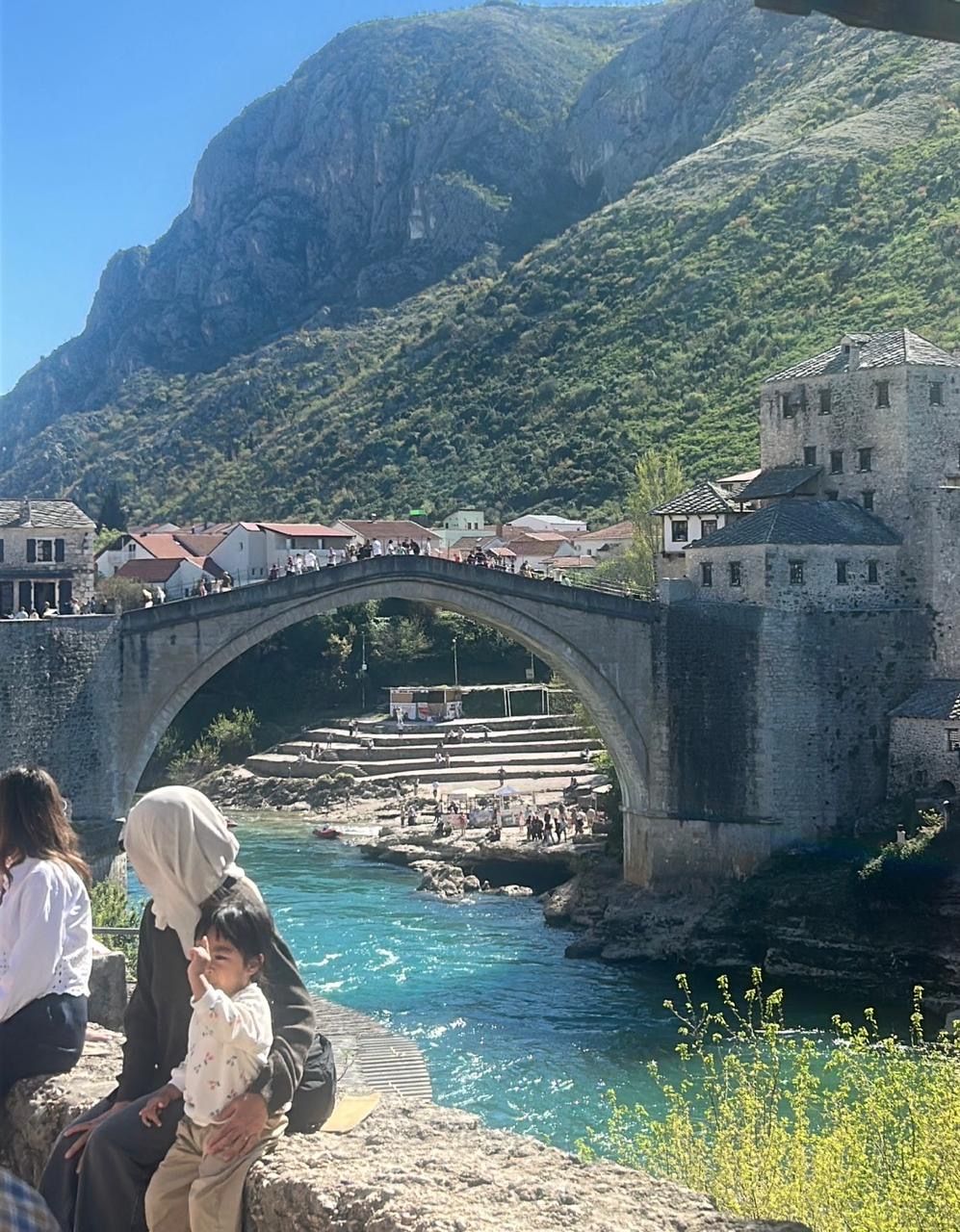 The Stari Most in Mostar during the day, people crossing the bridge