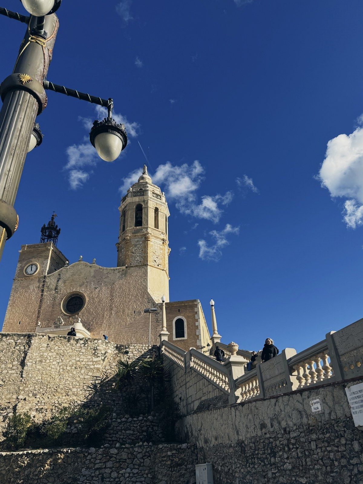 The Church of San Bartolomé and Santa Tecla in Sitges seen from below, blue sky