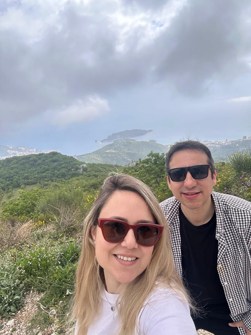 Couple at a mountain overlook with a view of the Montenegro coast