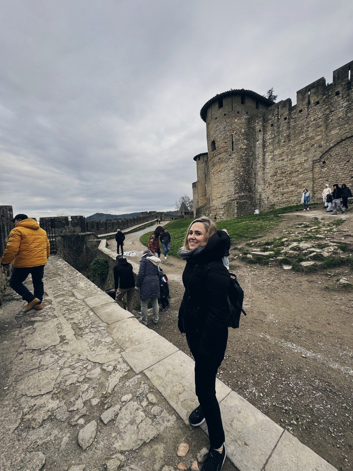 Carla walking along the Carcassonne ramparts