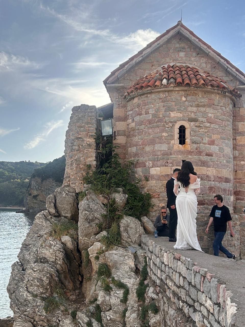 Wedding by a stone church on a cliff in Budva