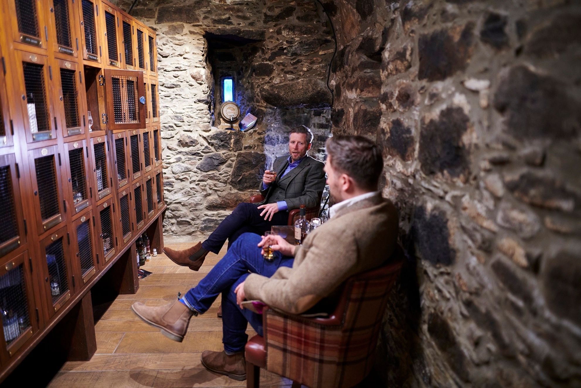 Barry and Dan, sitting, whisky locker