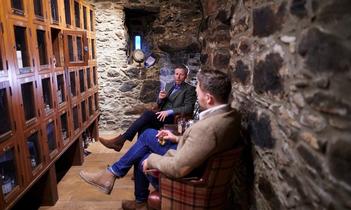 Barry and Dan, sitting, whisky locker