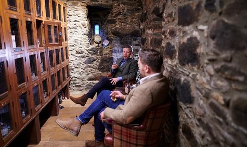 Barry and Dan, sitting, whisky locker