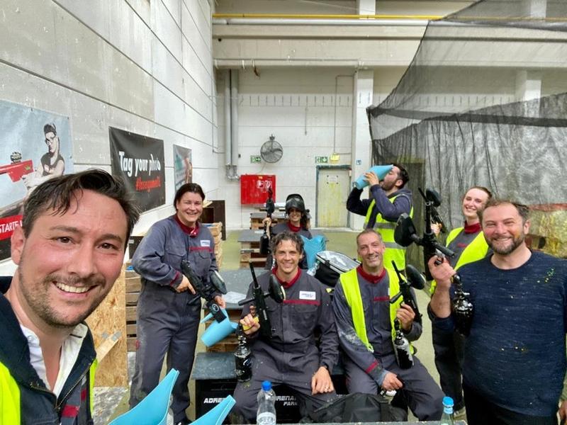 Team selfie in protective overalls after the paintball event