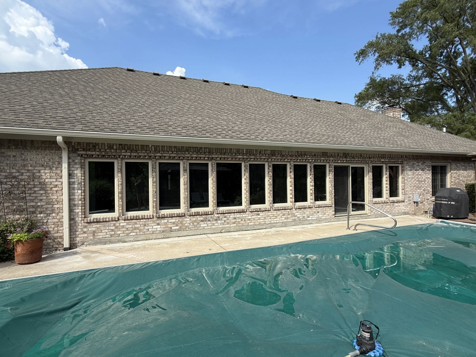 Completed sunroom conversion in Lawrence with new windows and brick exterior