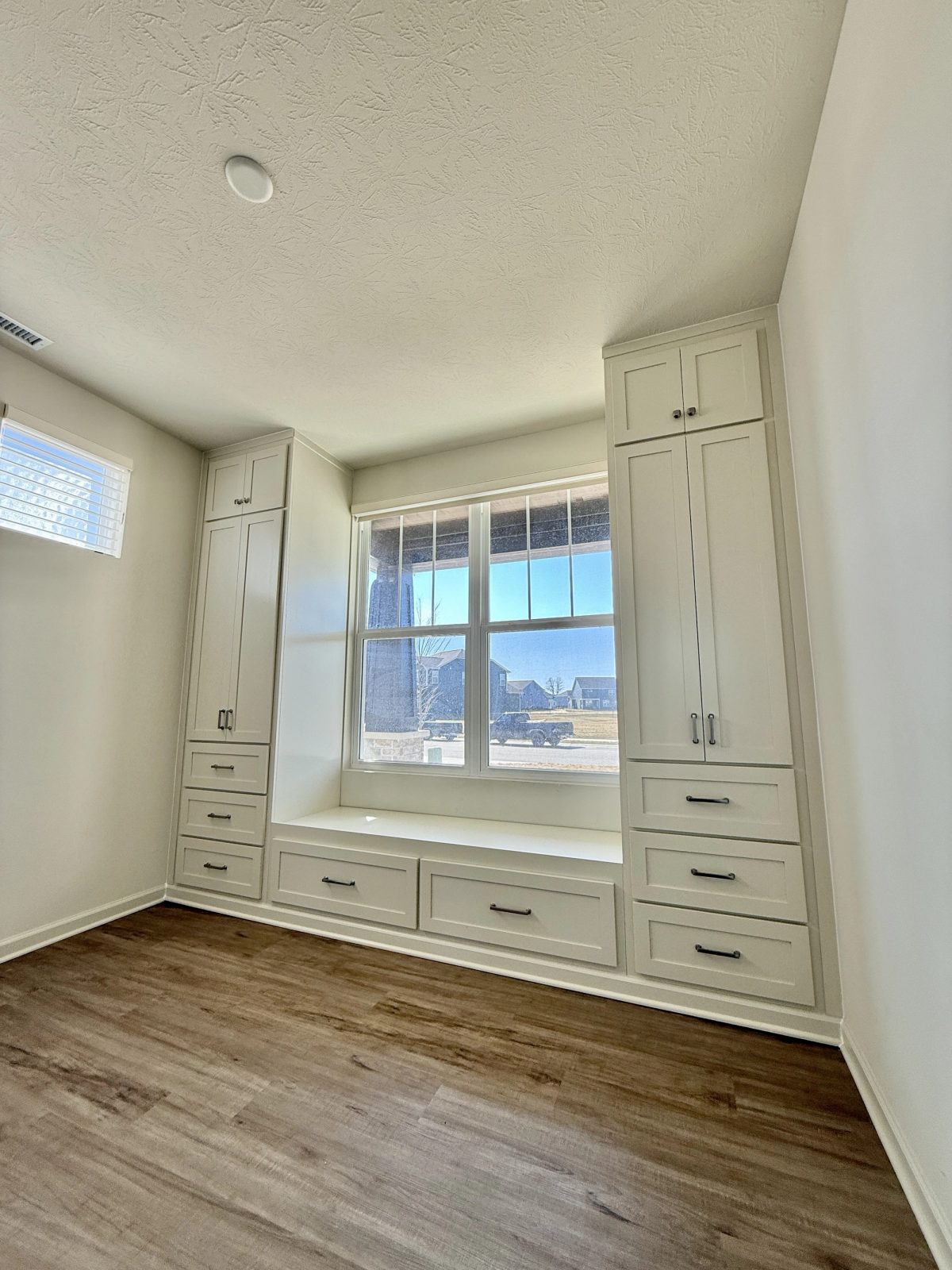 Installed floor-to-ceiling built-in cabinetry with window seat in Zionsville Indiana