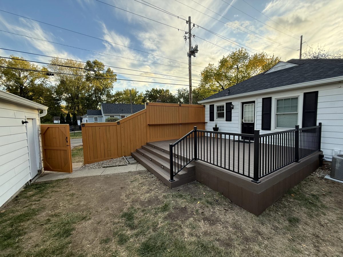 Completed composite deck with aluminum railing and cedar privacy fence in Fountain Square Indianapolis
