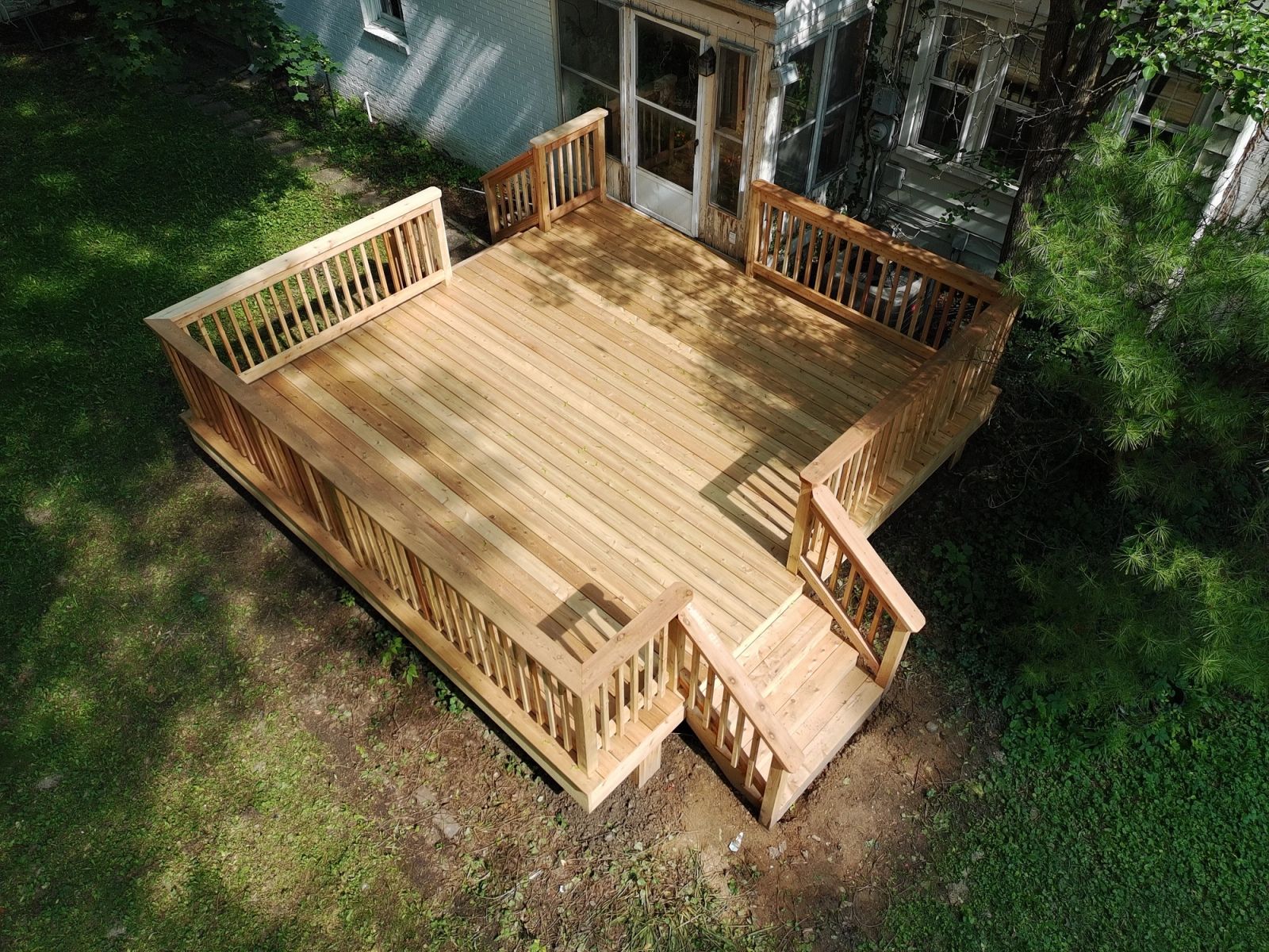 Greenwood pressure-treated deck construction with premium cedar railing system