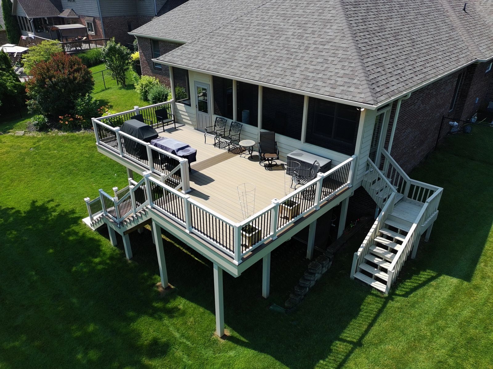 Elevated composite deck in Gary Indiana showing white railing and two-tone decking