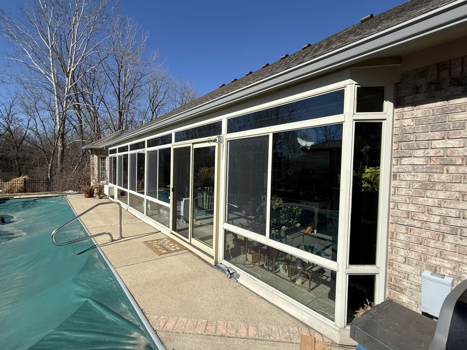 Before photo of dated aluminum screened porch in Lawrence Indiana