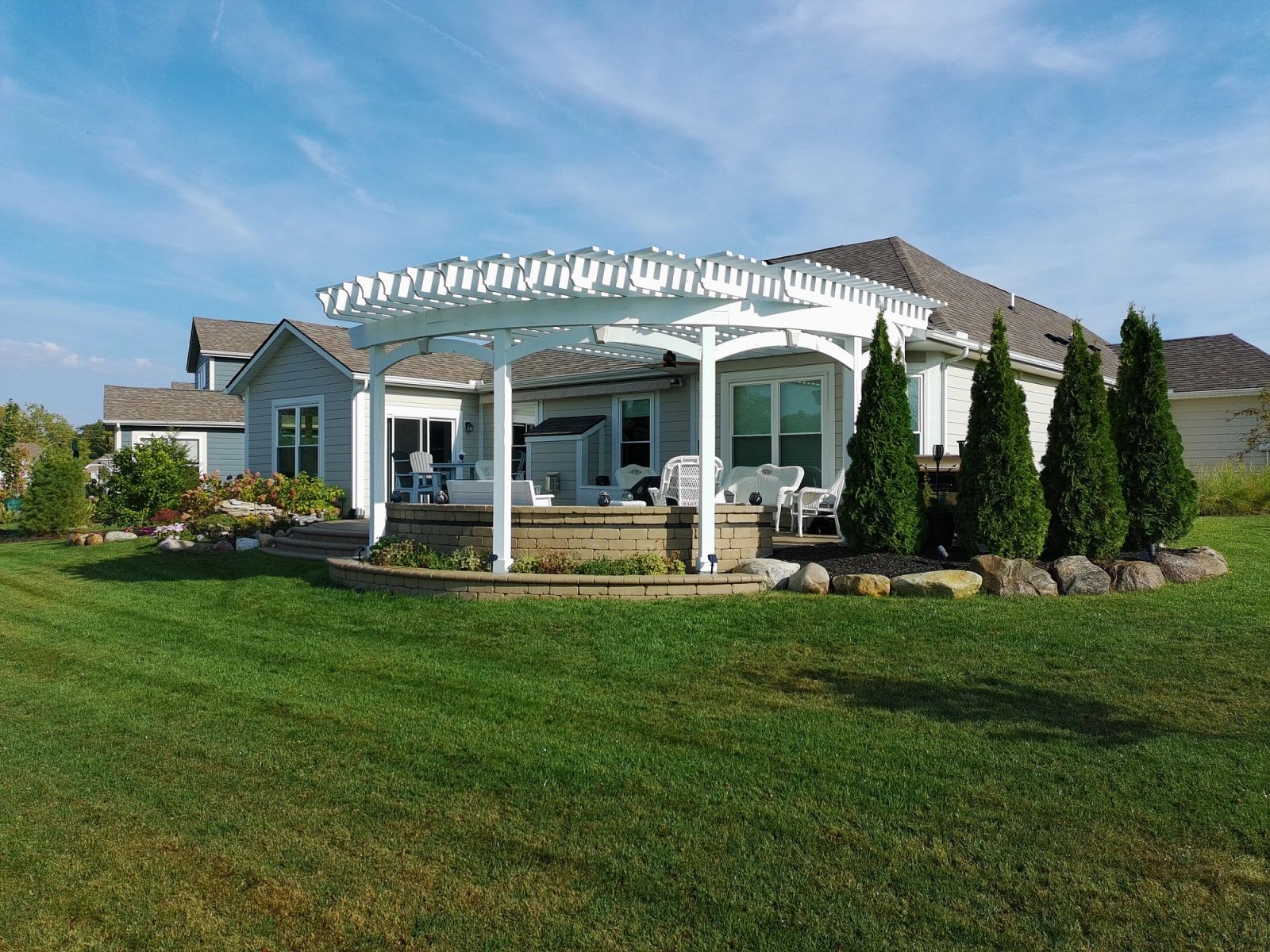 Custom white pergola with lattice detail and composite deck in Plainfield Indiana