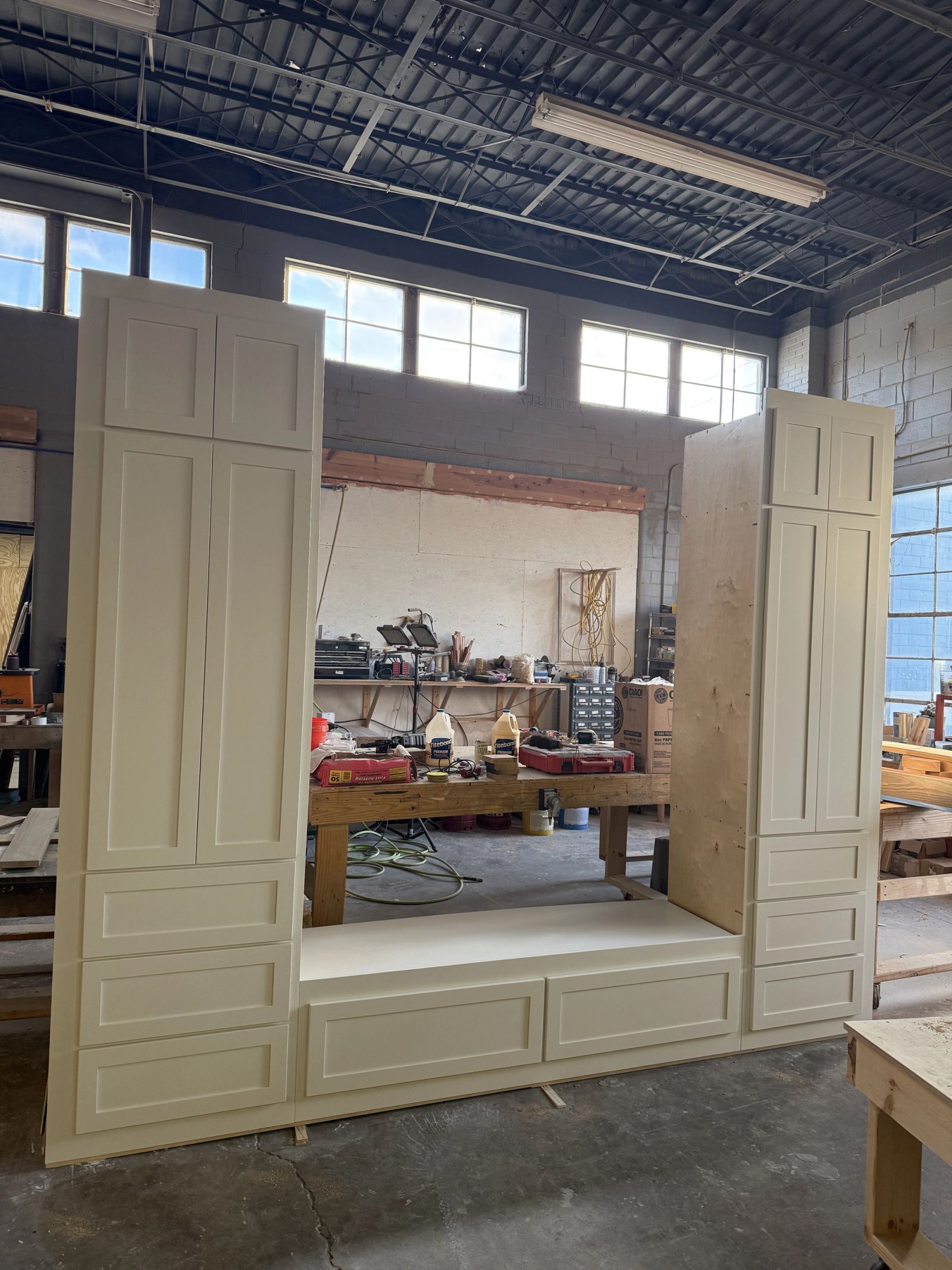 Custom built-in cabinetry under construction in millwork shop showing shaker-style details