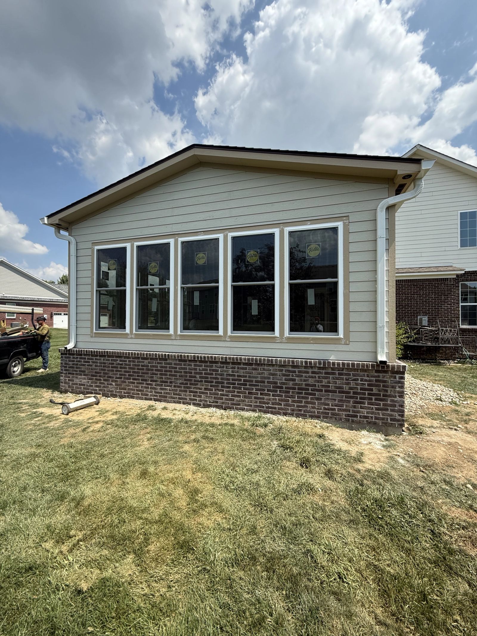 Detail view of Avon sunroom addition with gabled roof and trim work